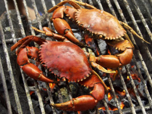 Two grilled crabs on grill